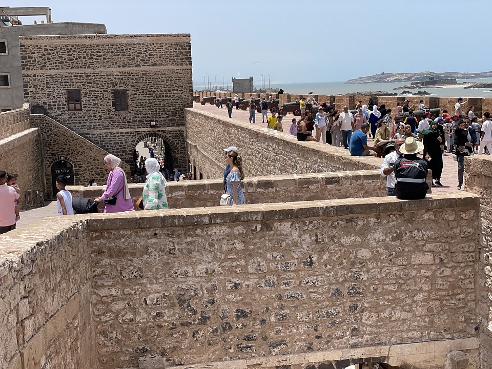 Essaouira, la perle de l'Atlantique ! 🌊 C'est une ville côtière charmante, connue pour ses remparts, son port de pêche et ses plages de rêve. Voici quelques idées d'excursions :  - *Visite de la Médina* : Découvrez les rues étroites et les marchés colorés de la Médina, classée au patrimoine mondial de l'UNESCO. - *Port de pêche* : Admirez les pêcheurs décharger leurs prises et les bateaux traditionnels. - *Plage de la ville* : Détendez-vous sur la plage de sable fin et profitez du soleil. - *Skull Island* : Faites un tour en bateau vers l'île de Mogador, un site naturel protégé. - *Marché d'artisans* : Découvrez les artisans locaux et leurs créations en bois, en cuir et en textiles.  Vous pouvez également pratiquer des activités comme le surf, le kwindsurf ou la pêche au large.